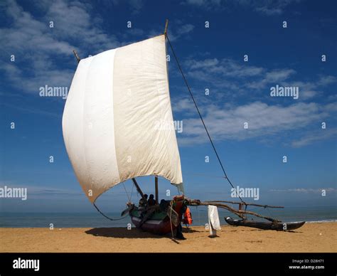 Sri Lankan Fishing Boat With Stabilising Outrigger On The Beach At