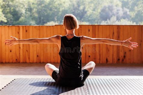 Slim Blonde Woman Sits On A Fitness Mat Stretches Her Body Outdoors Panorama With Copy Space