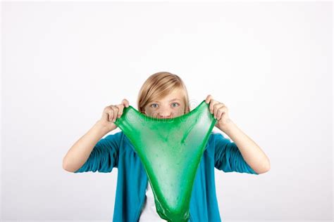 Funny Girl Holding Green Slime Looks Like Gunk In Front Of Her Face