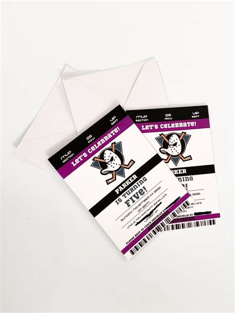 two hockey tickets sitting next to each other on top of a white table ...