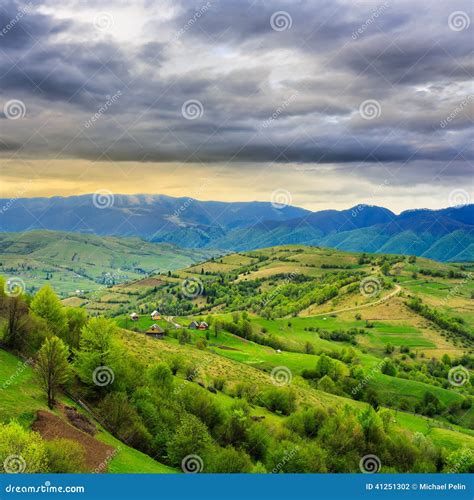 Village On Hillside Meadow With Forest In Mountain Stock Photo Image