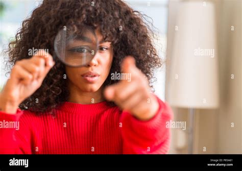 Curious African American Woman Looking Through Magnifying Glass