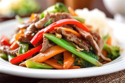 Premium Ai Image A Plate Of Beef Stir Fry With Vegetables