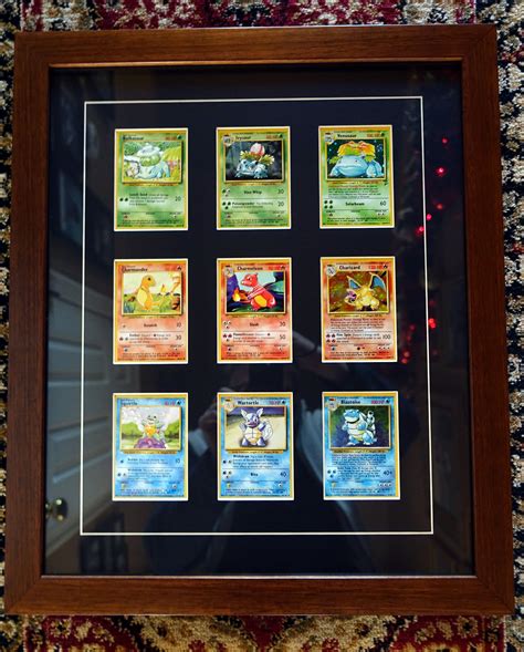 The Pokemon Trading Card Collection Is Displayed In A Shadow Box On A