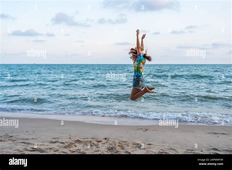 Woman Enjoy And Jumping On The Sea Beach Stock Photo Alamy