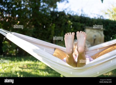 Girl With Feet Up Relaxing In Hammock Stock Photo Alamy