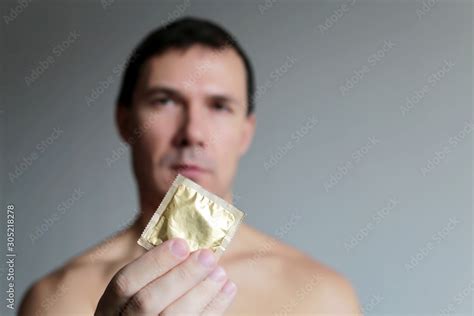 Condom In Male Hands Close Up Safe Sex Man Giving Condom In Package Concept Of Contraception