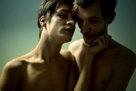 Two Naked Men Standing Next To Each Other Looking At Something In The