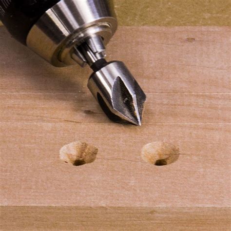 A Drill Is Being Used To Make Holes In The Wood