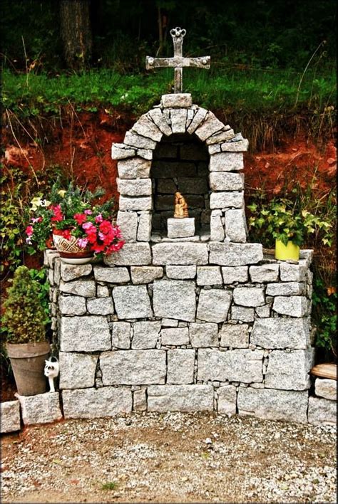 A Stone Fire Place With A Cross On Top