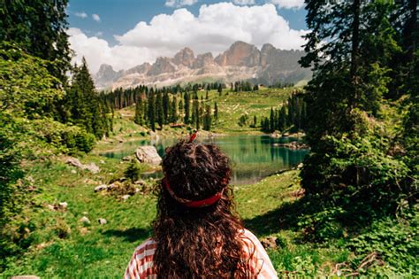 Rear View Of A Woman While Shes Admiring Carezza Lake In Dolomites