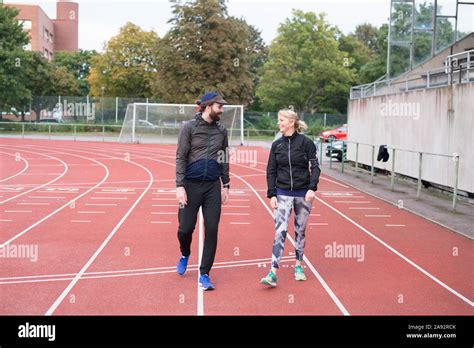 Man And Woman On Running Track Stock Photo Alamy