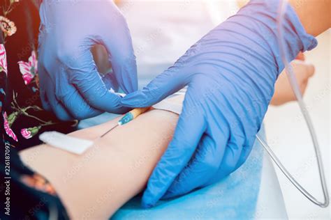 Medical drip tubing and patient at the hospital. Stock Photo | Adobe Stock