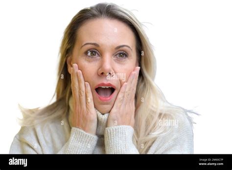 Attractive Blond Middle Aged Woman With Both Hands On Her Cheeks With A Very Amazed Face