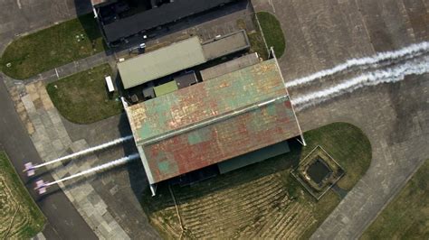 Two Planes Fly Through A Hangar Red Bull Barnstorming YouTube