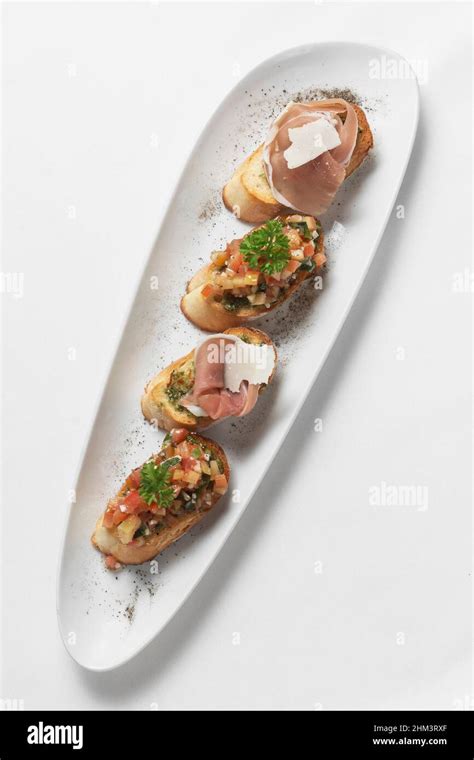 Basque Pinchos Tapas With Jamon Serrano Ham And Tomato Bruschetta On