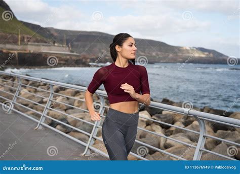 Pretty Brunette Jogging By The Sea Stock Image Image Of Brown
