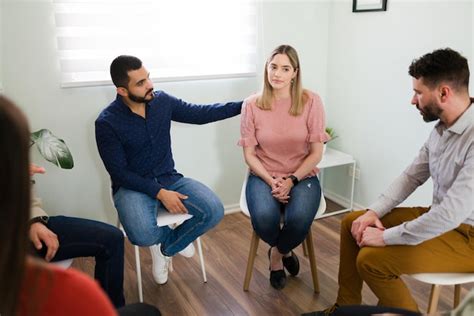 Free Photo Male Member At An Aa Meeting Comforting A Caucasian Woman