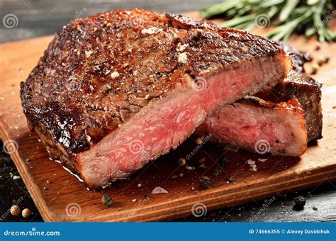 Medium Rare Ribeye Steak On Wooden Board Selected Focus Stock Image