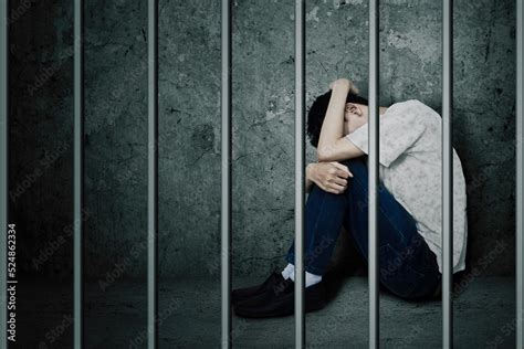 Sad Man Sitting Behind Bars In The Jail Stock Photo Adobe Stock