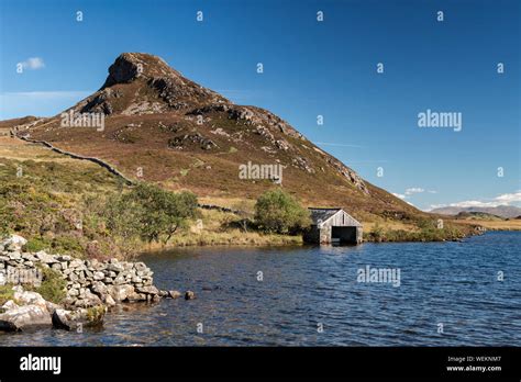 View Of The Boathouse At Cregennan Lakes Under A Clear Blue Sky With