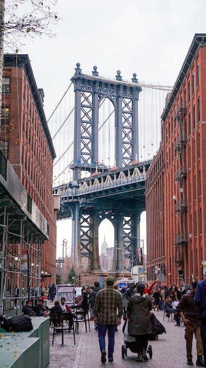 Brooklyn Bridge Seen between Buildings · Free Stock Photo