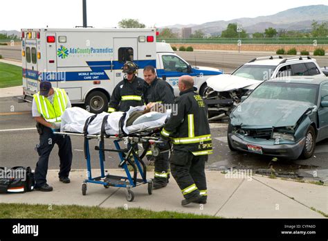 Paramedics And Firefighters Respond To An Automobile Injury Accident In