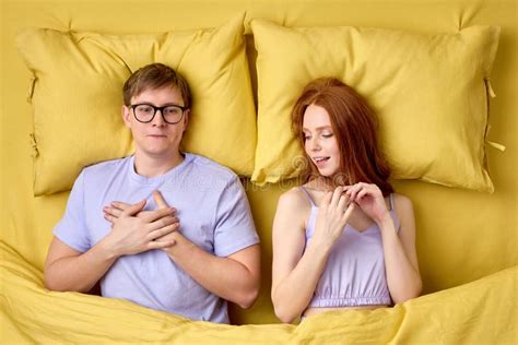 Happy Couple Lying In Bed Under Duvet After First Sex Experience Man Is Surprised By Skills Of