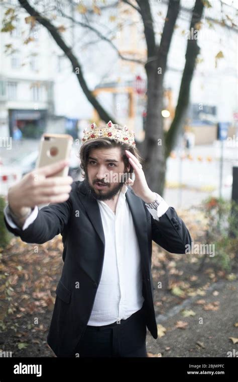 Vain Man With Crown Taking Selfie Stock Photo Alamy