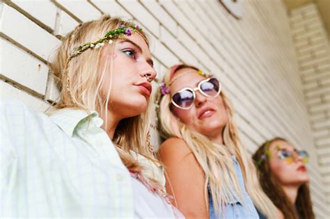 Three Beautiful Caucasian Women Standing By White Brick Wall Sisters Or