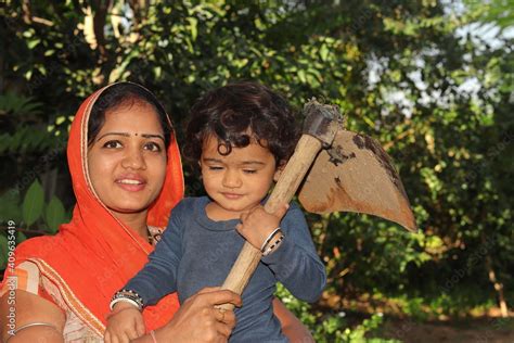 Beautiful Indian farmer woman and a young Indian Hindu farmer child ...