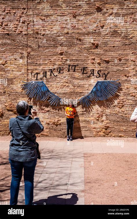 A Girls Poses For A Photograph In Front Of Metallic Wings The Eagles