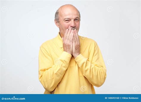 Mature Bald Man Covering Mouth And Laughing Stock Photo Image Of