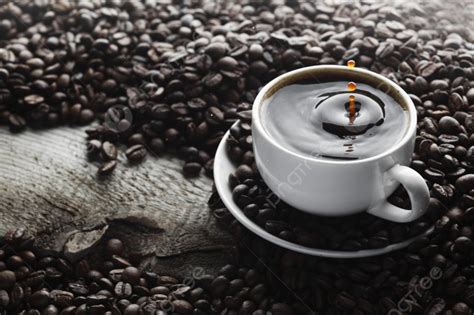 Coffee Splash In White Cup Over Roasted Coffee Beans Background And