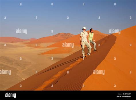 Two Women Standing On Red Sand Dune In Sossusvlei Dune 45 Sossusvlei Namib Naukluft National