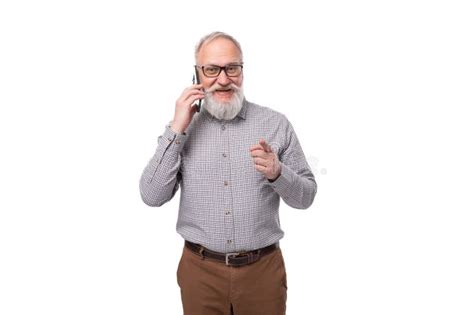 A Gray Haired Mature Man With A Beard And Mustache In Trousers And A