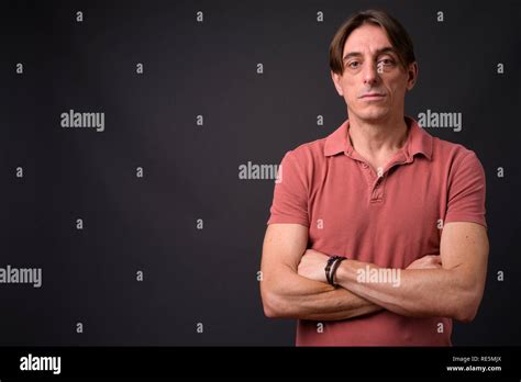 Mature Handsome Italian Man Against Gray Background Stock Photo Alamy