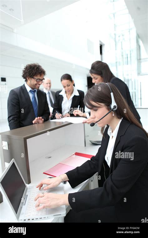 Female Receptionist Using A Headset And Laptop Computer Stock Photo Alamy