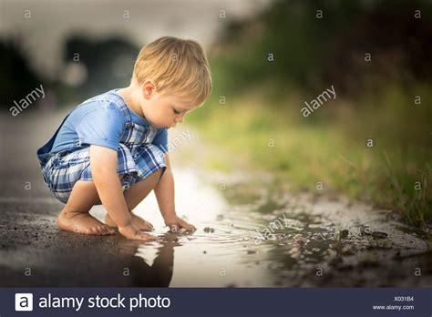 Boy In Puddle High Resolution Stock Photography And Images Alamy