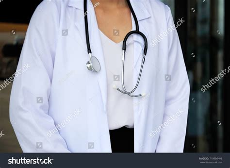 Doctor Wearing White Gown Hanging Stethoscope Stock Photo