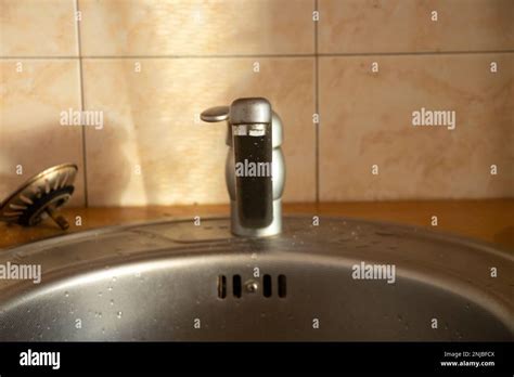 Cold And Hot Water Tap In The Kitchen Sink Stock Photo Alamy