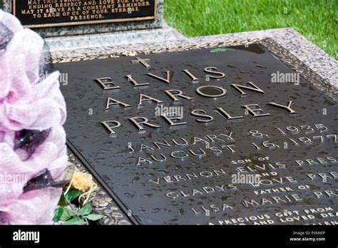 Elvis Presleys Grave Surrounded By Flowers And Tributes On The 40th