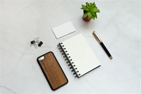 Flat Lay Of A Blank Notepad Pen Phone Clips Paper Cards And A Plant On ...