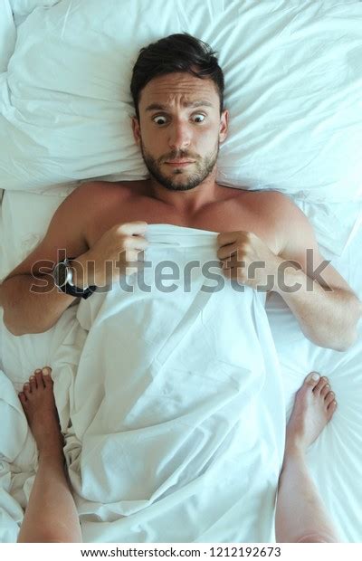 Handsome Man Laying Naked Bedroom Surprised Stock Photo 1212192673