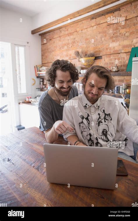Gay Couple Using A Laptop Together Stock Photo Alamy