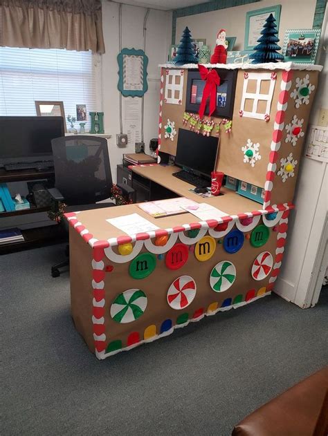 An Office Cubicle Decorated For Christmas With Gingerbreads And Candy