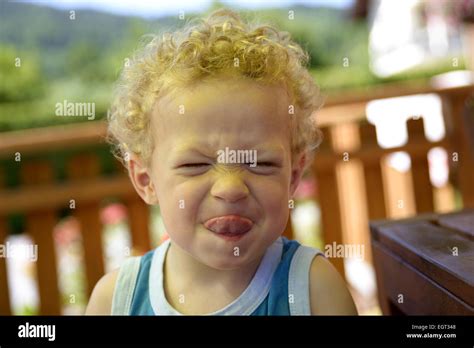 Child Makes A Grimace And Smile Stock Photo Alamy