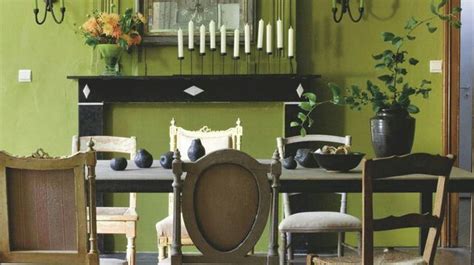 A Dining Room With Green Walls And Chairs