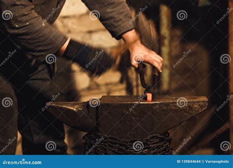 The Blacksmith Manually Forging The Red Hot Metal On The Anvil In Smithy Stock Photo Image Of