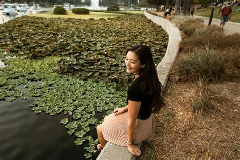 Smiling Woman Sitting at a Park · Free Stock Photo